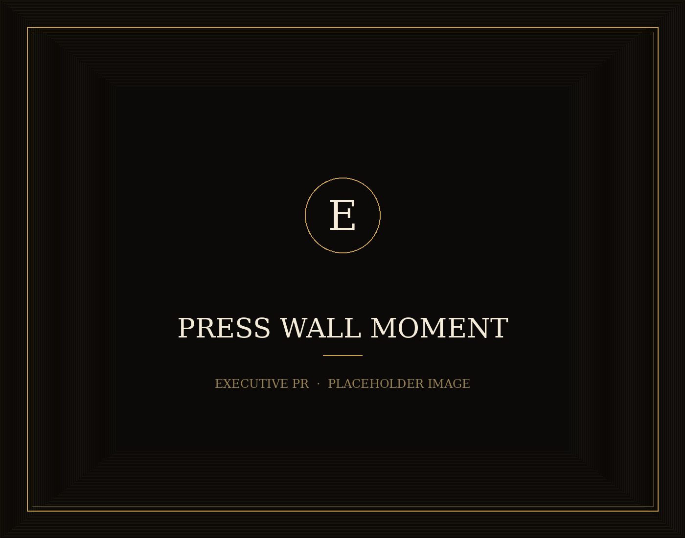 A press wall lit for arrivals as photographers prepare to capture guests